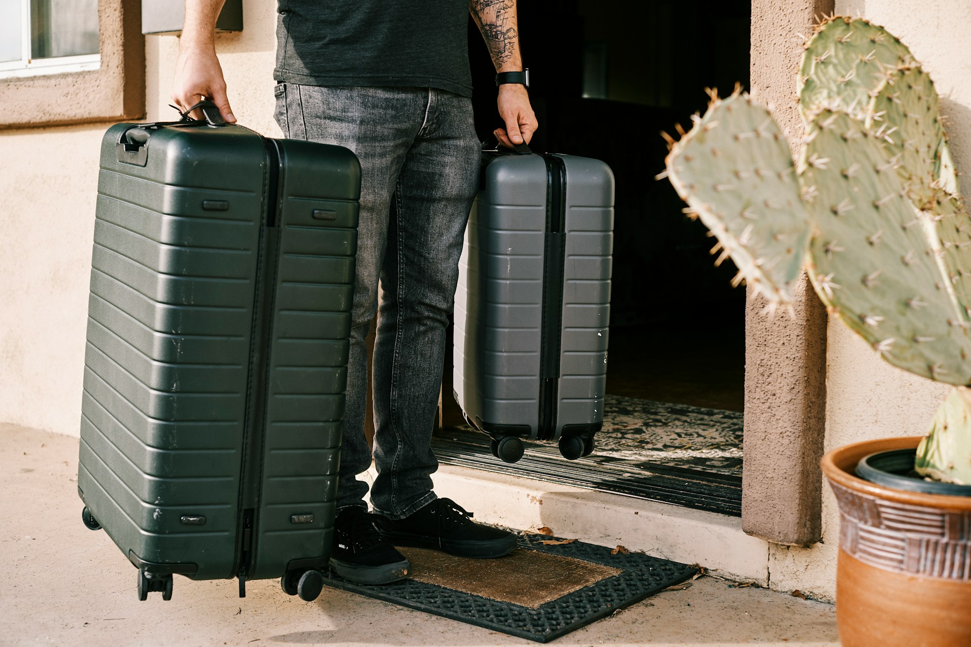 Person holding two suitcases